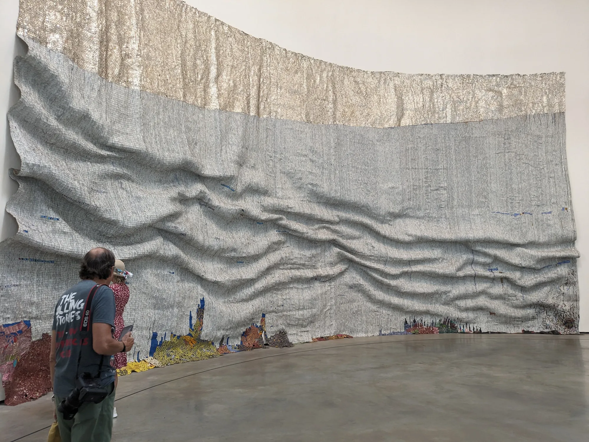 el anatsui, installation view into the atrium with his large scale work "raising sea" at Guggenheim Bilbao, questioning climate crises in contemporary art now