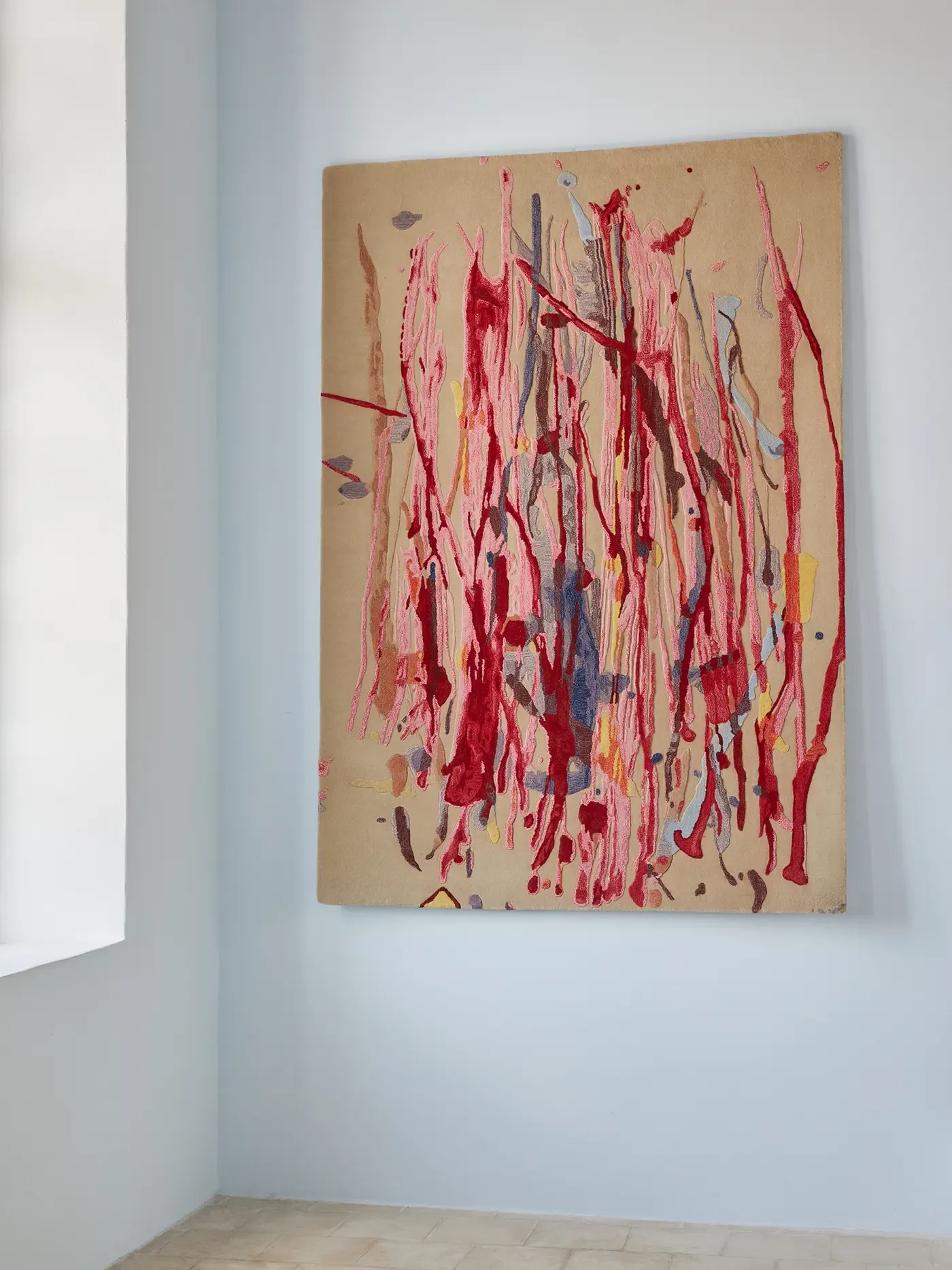 helen marden's watercolor translated into a handmade carpet by soutzoglou artisans. detailed view and serene setting