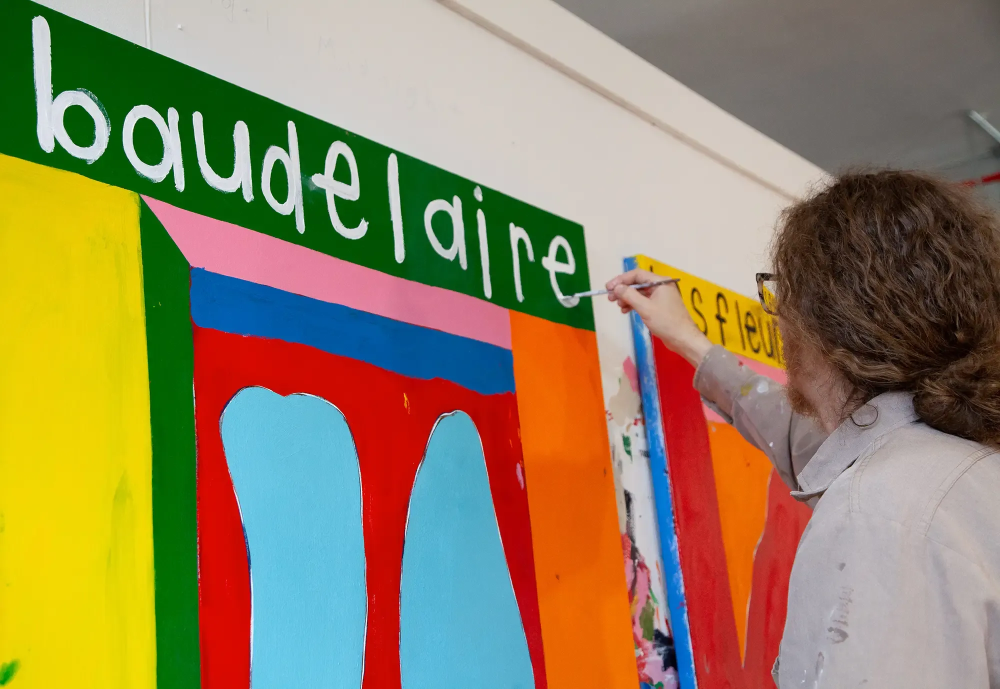 joseph o'neal painting in his studio with text-based contemporary art