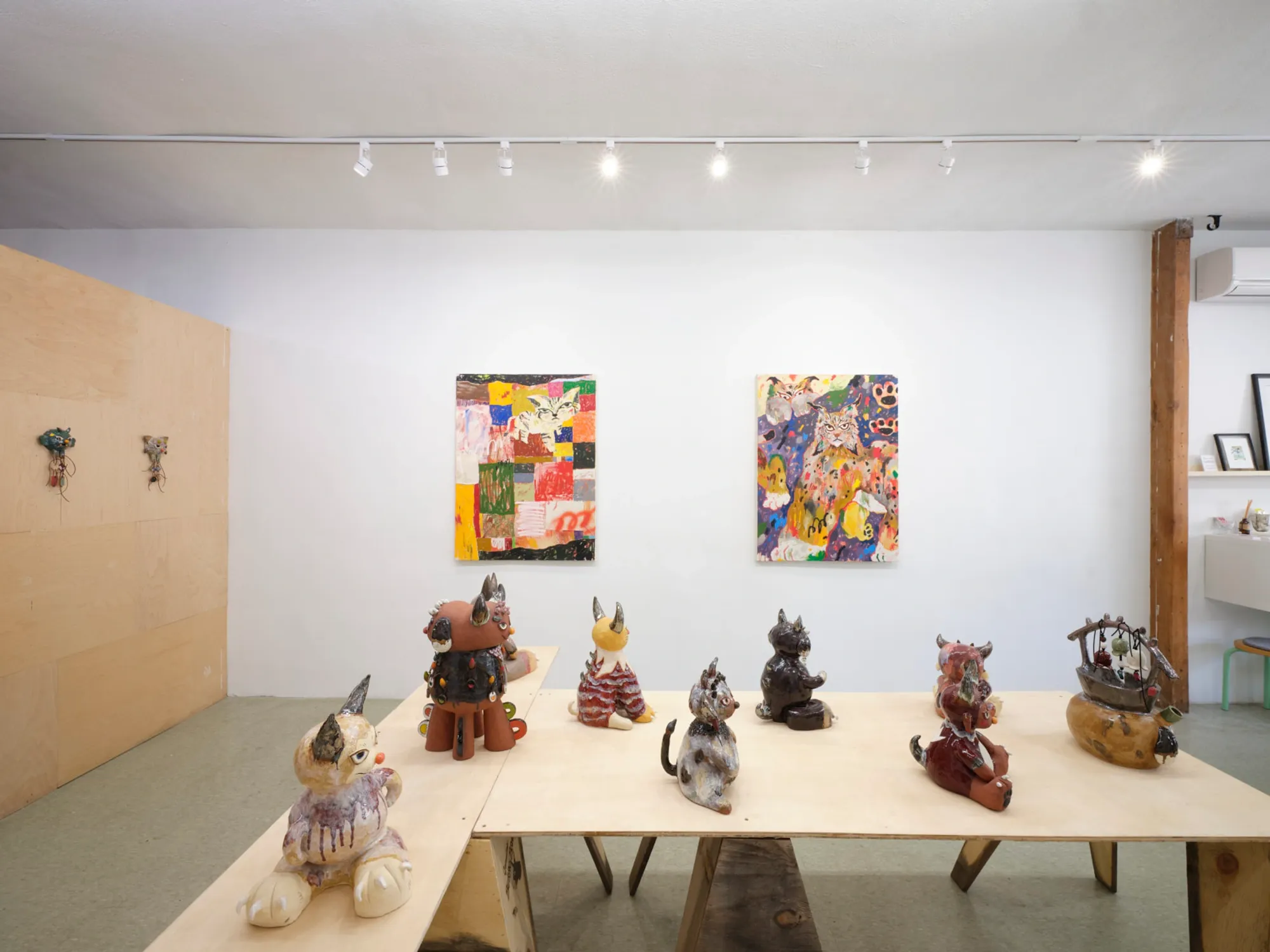 Satoko Okuno’s studio view with multiple guardian figures lined up like shrine protectors