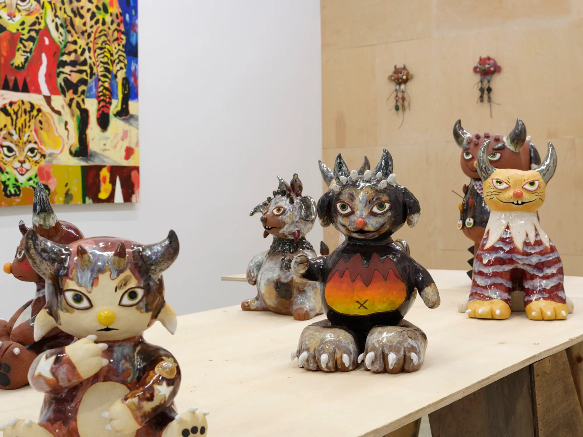 Colorful ceramic sculpture by Satoko Okuno resembling a mythical cat-guardian, glazed and alert