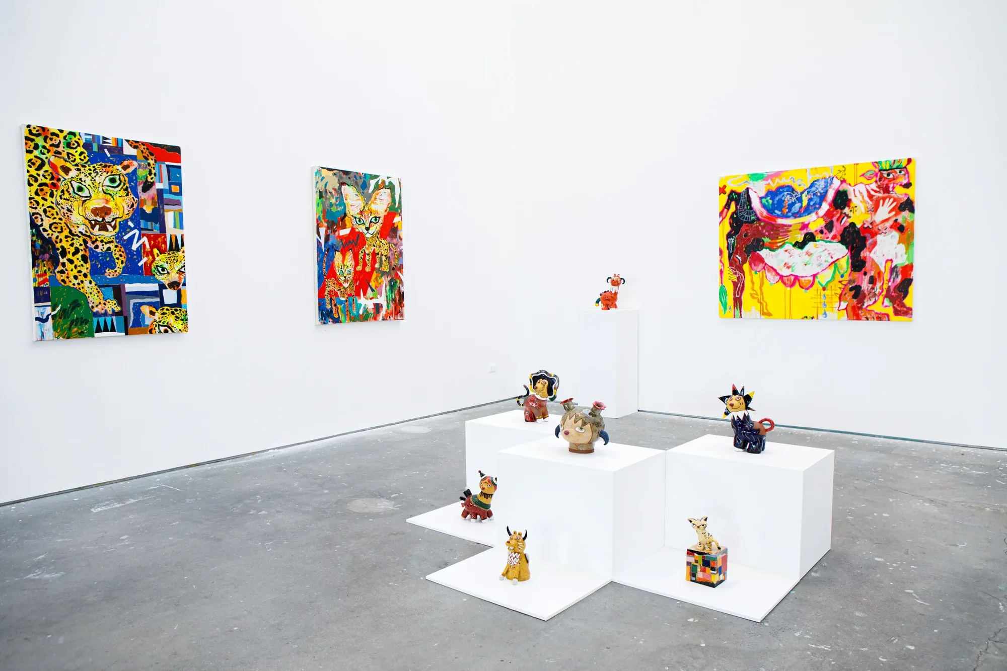Installation view of Satoko Okuno’s undergraduate show with colorful guardian animals lining the gallery wall