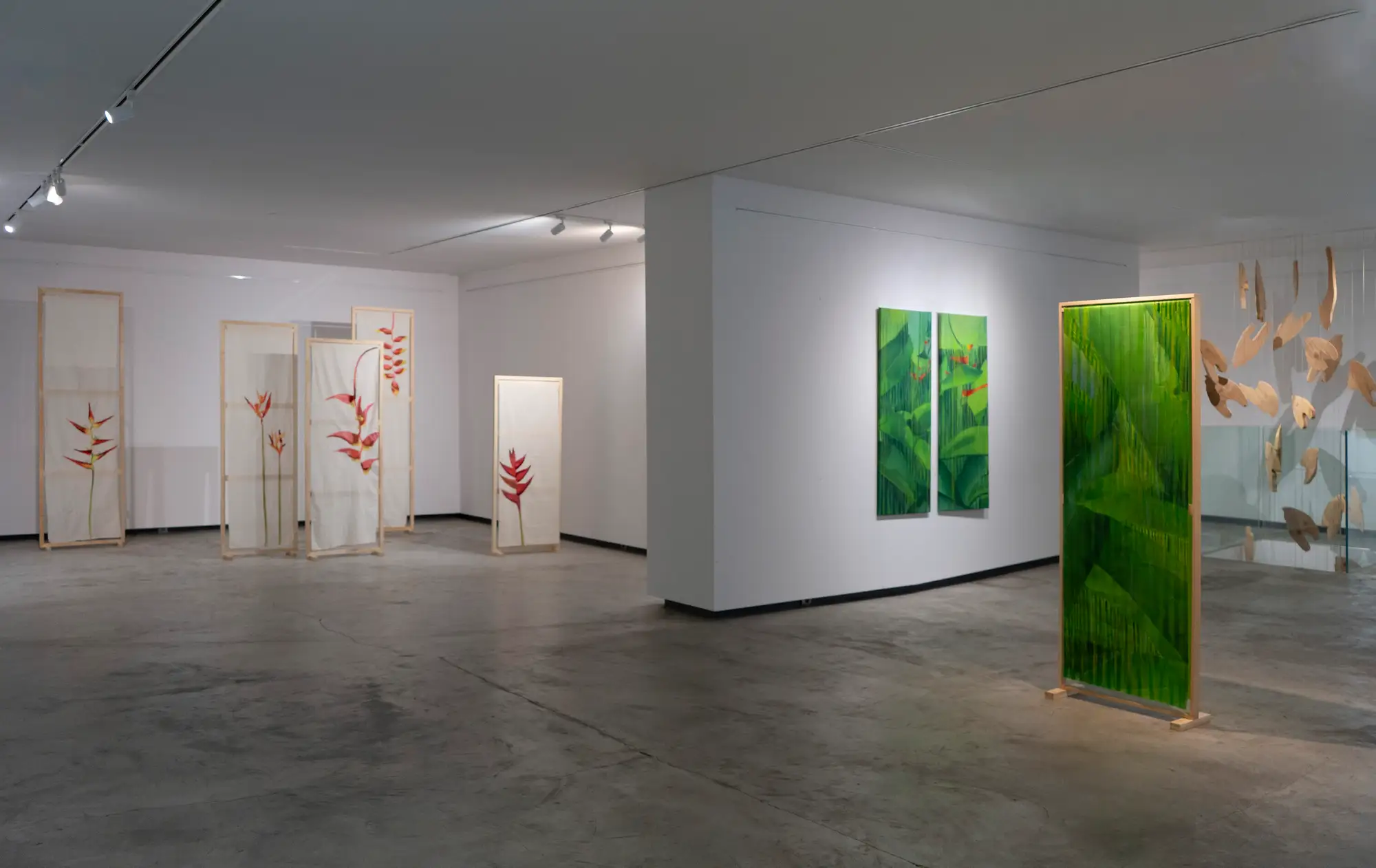Installation fragment with two canvases placed in dialogue across a space, installation view