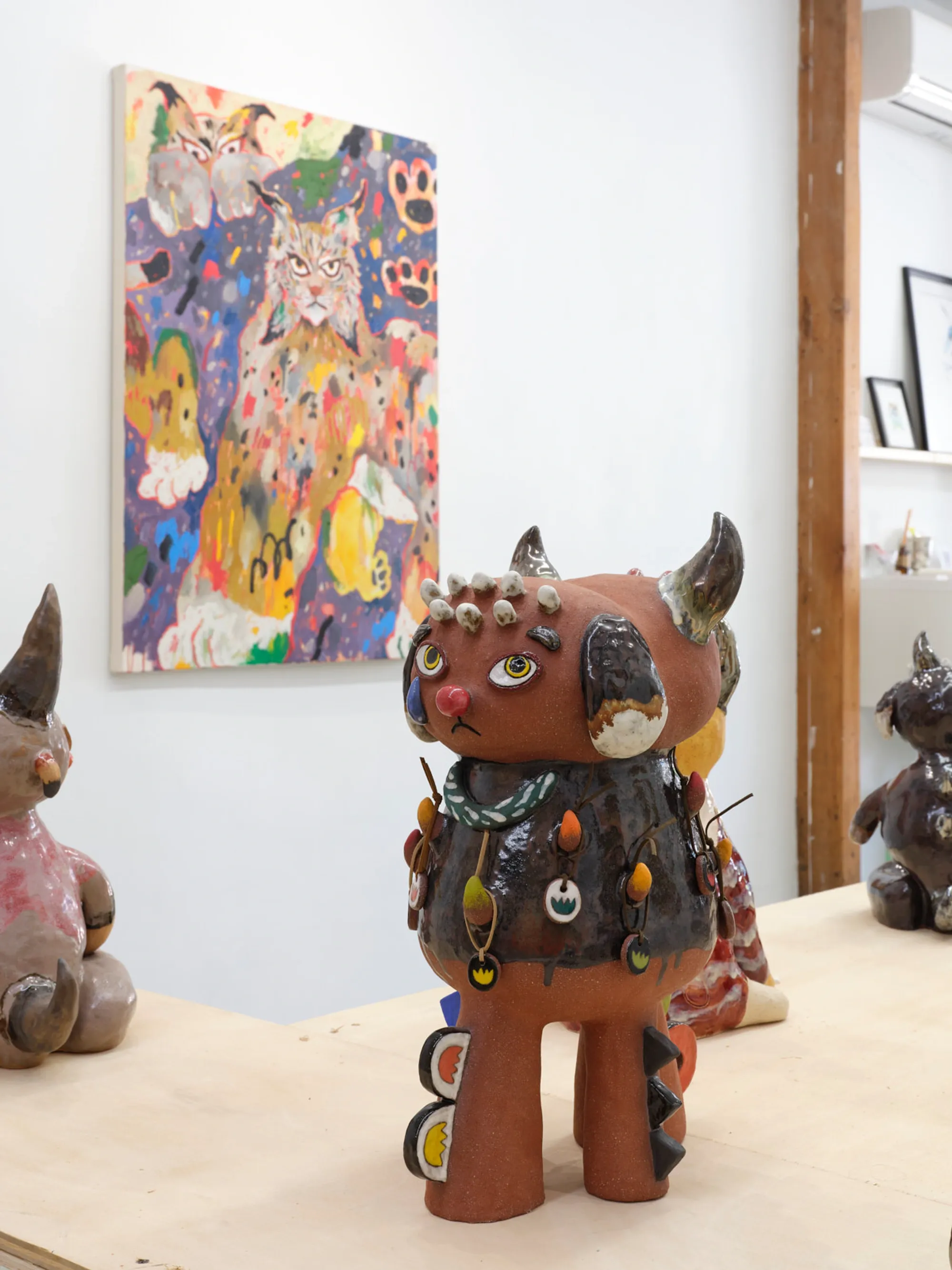 Hybrid animal sculpture combining feline and horned elements, standing protectively.
