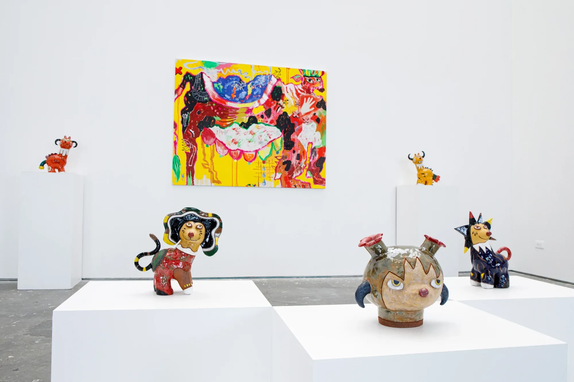 Glazed ceramic guardian figures by Satoko Okuno displayed on pedestals, radiating spiritual calm.