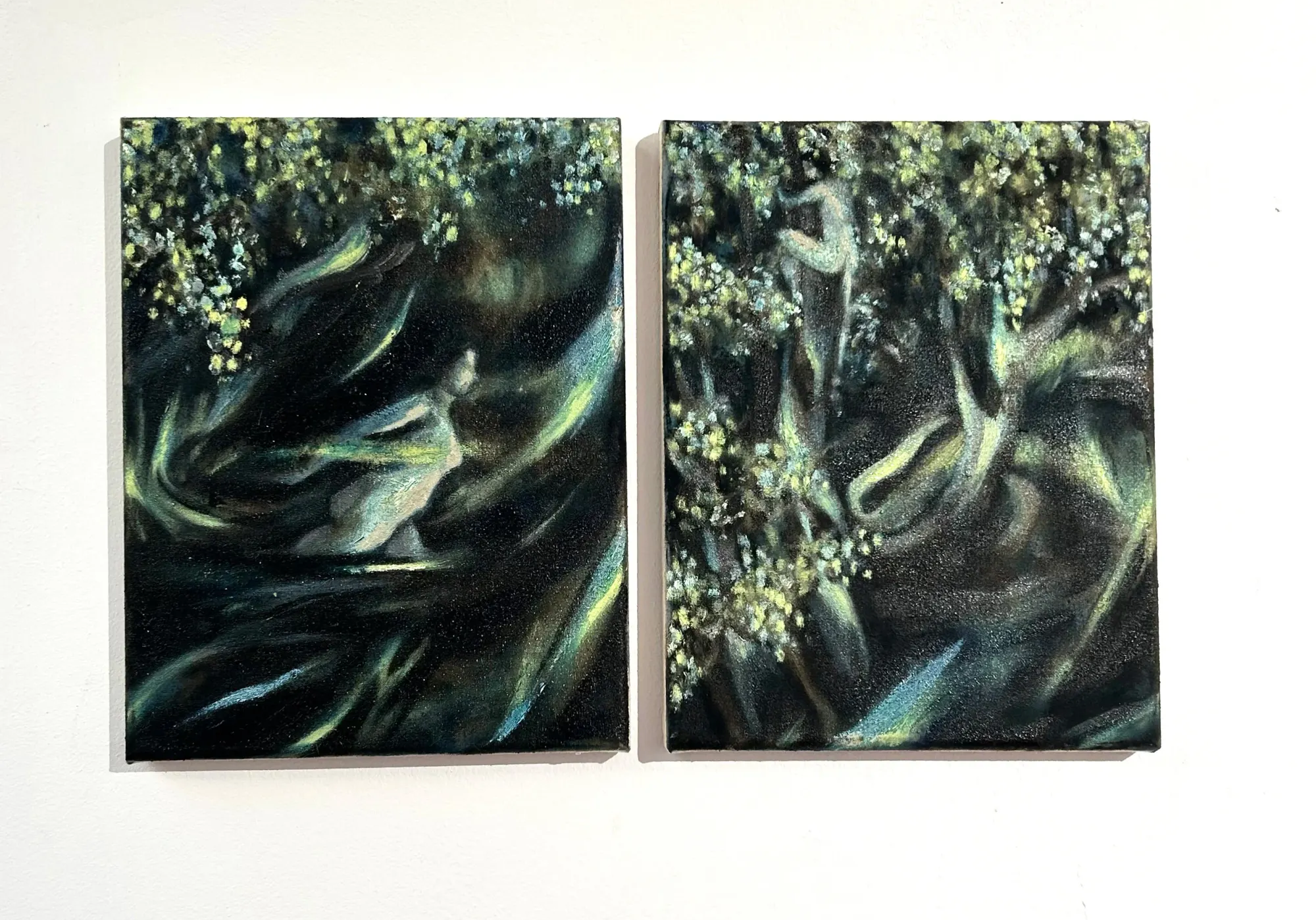 Candy Bassas, making of, two small nocturnal canvases with figures emerging from dark green foliage, Berlin studio process.