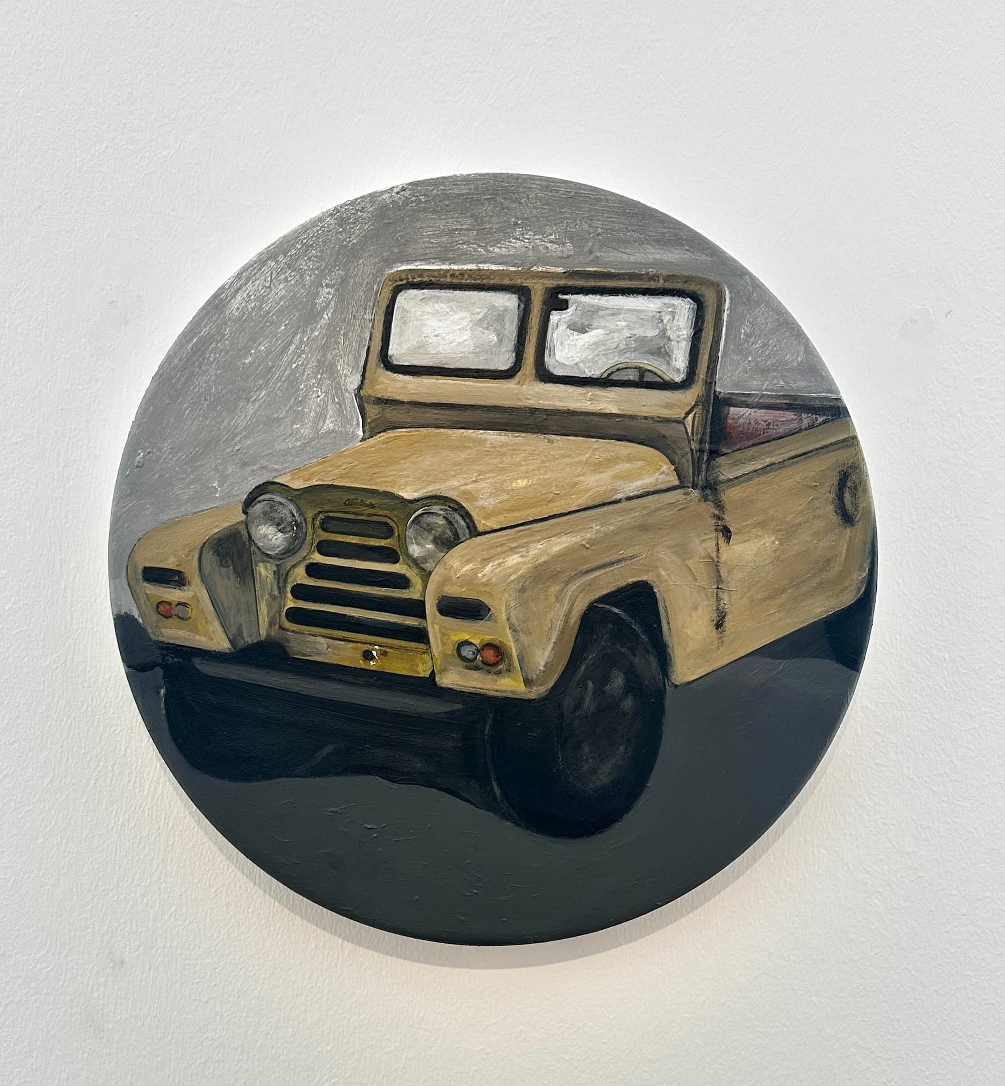 Alt text: Room view at Klubhaus showing a small round Jeep painting from “1996.”