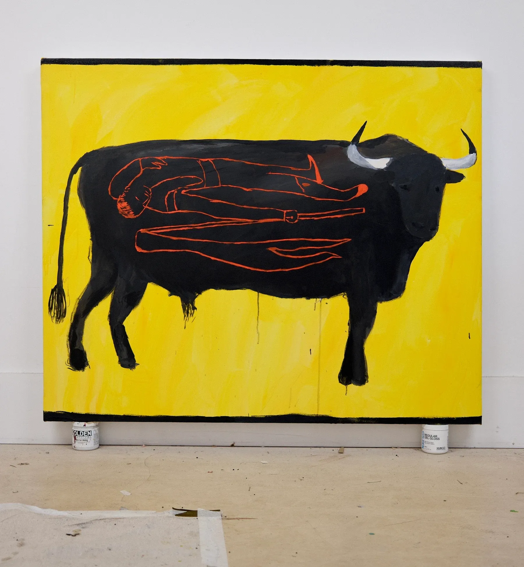 Painting by Billy Bagilhole showing a large black bull against a bright yellow background, with red outlines of a reclining human figure drawn inside the animal’s body.