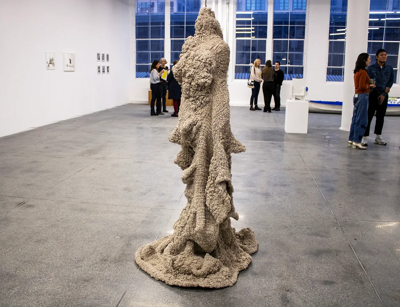 Yali Romagoza, Landscapes of Belonging, Sculpture #1 (2025), linen and thread sculpture shown in the group exhibition The Reality Principle at Monira Foundation, NJ, surrounded by visitors in a large gallery space.
