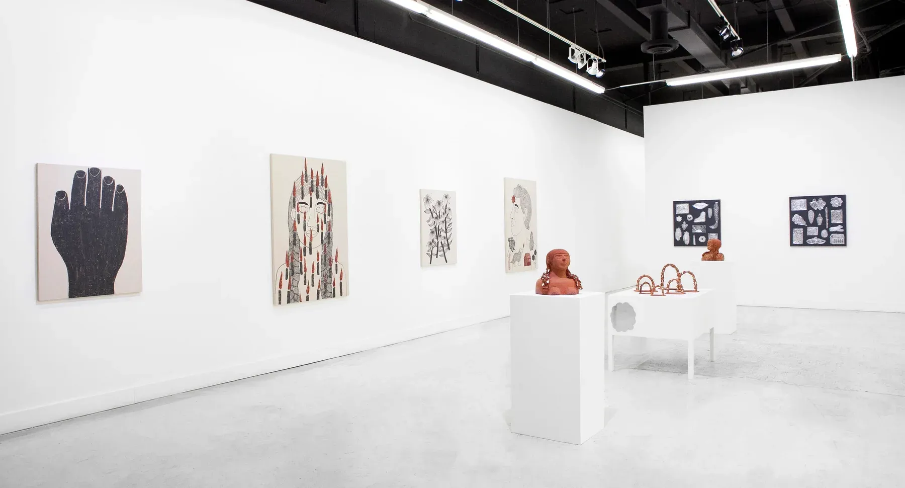 White gallery with terracotta sculptures on pedestals, surrounded by large figurative and botanical paintings.
