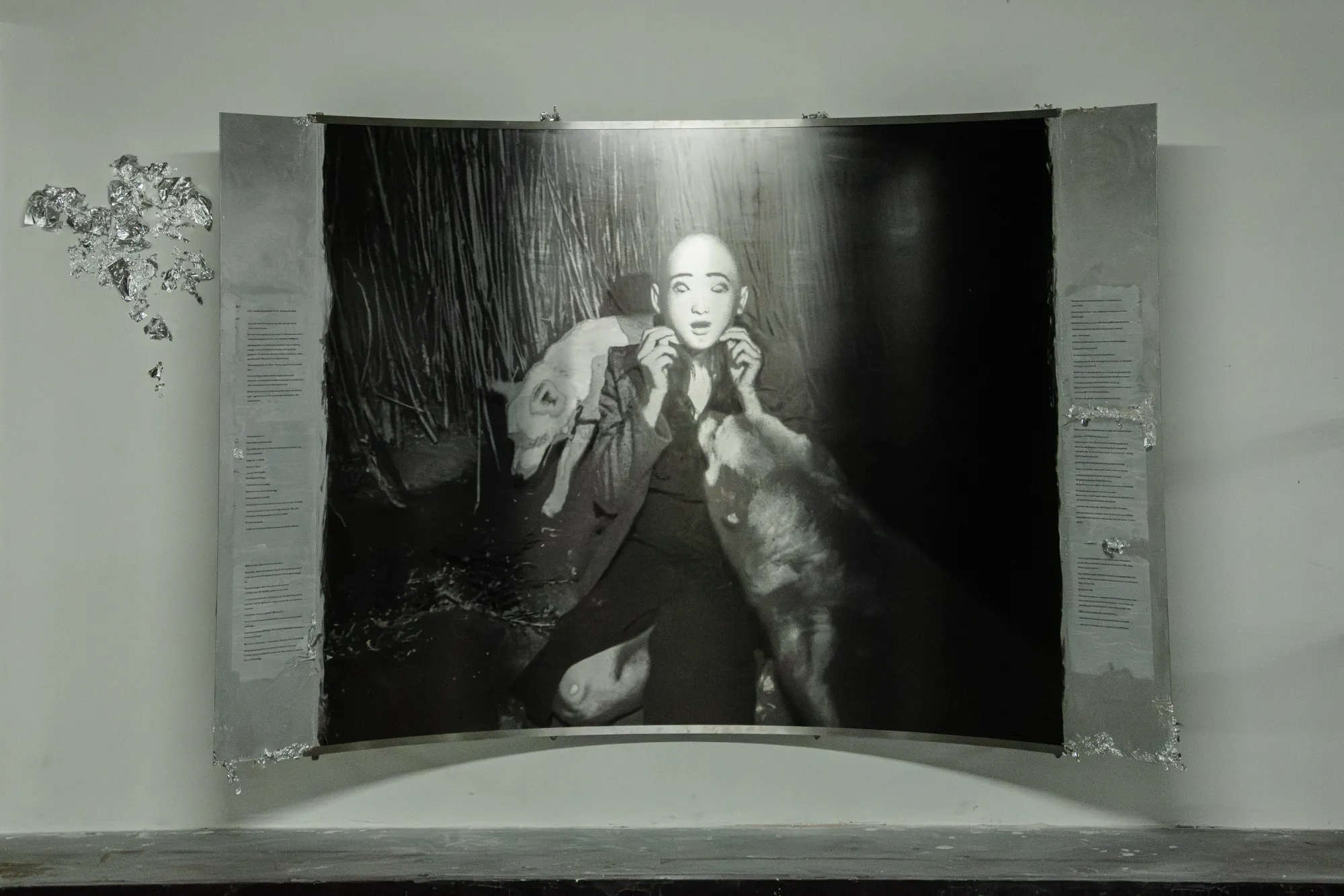 Installation view of After Unrast by Nadine Karl at Kunsthalle DĂĽsseldorf, showing a large black-and-white photographic work with sculptural and text elements.