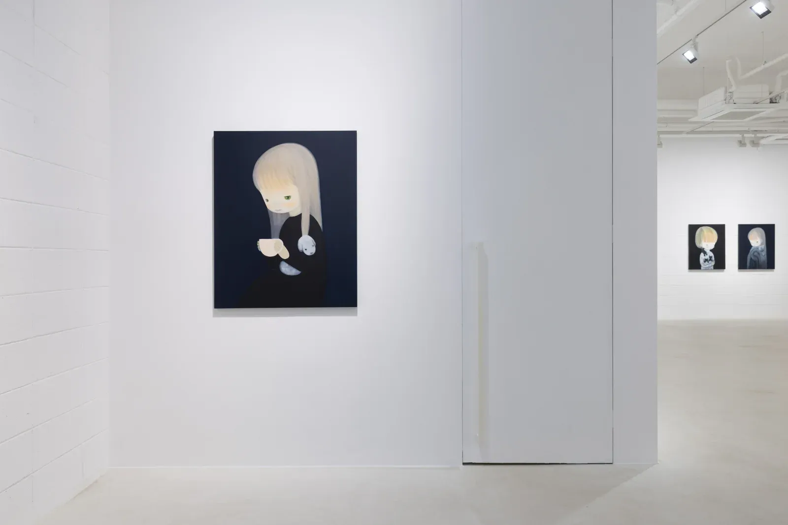Installation view featuring a painting by Ruo-Hsin Wu displayed in a minimalist gallery space at Eligere Gallery, with additional works visible in the background as part of a trio exhibition.