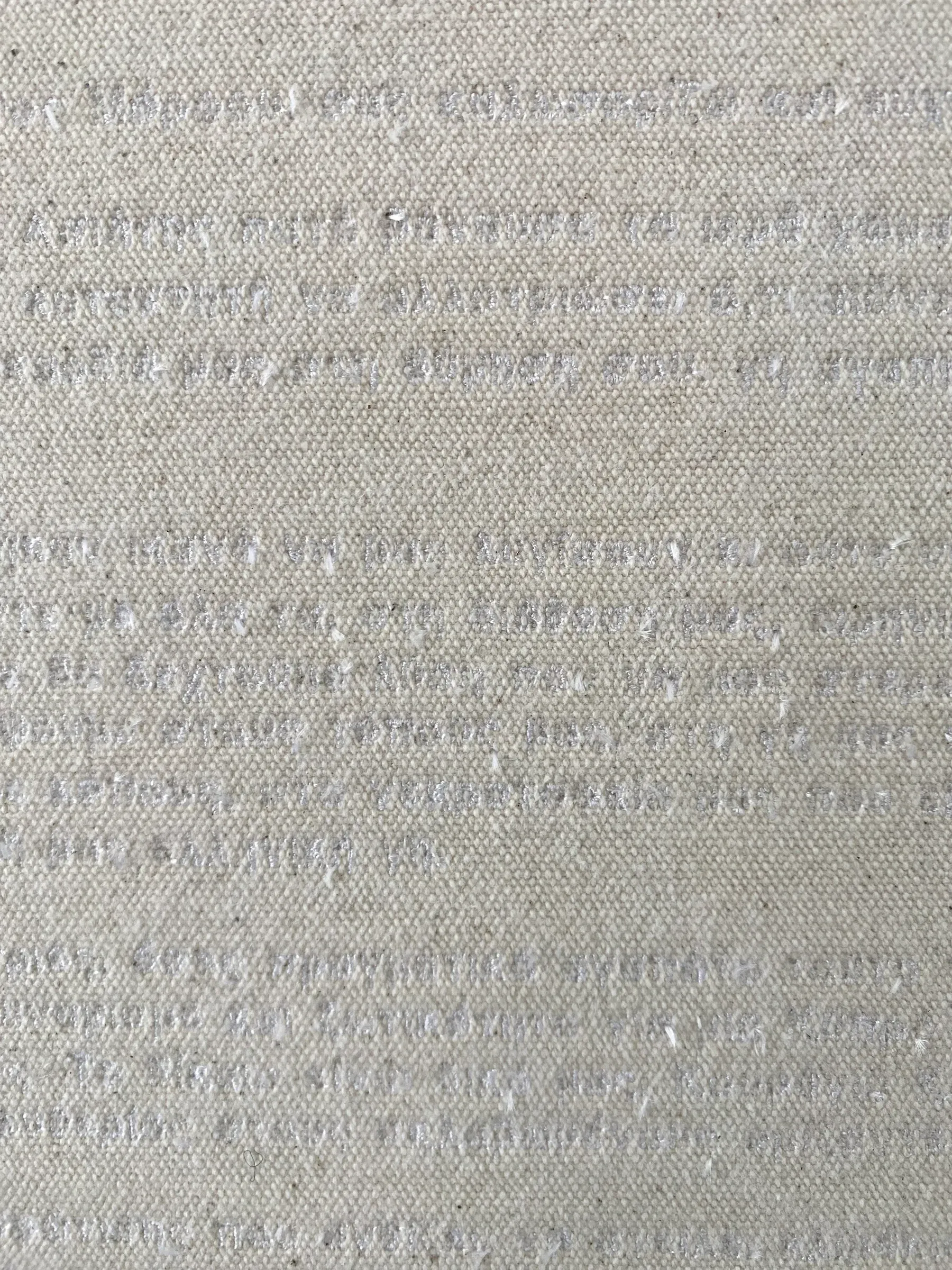 Detail of a canvas surface showing fine stitched lines of thread forming faint text embedded into the fabric texture.