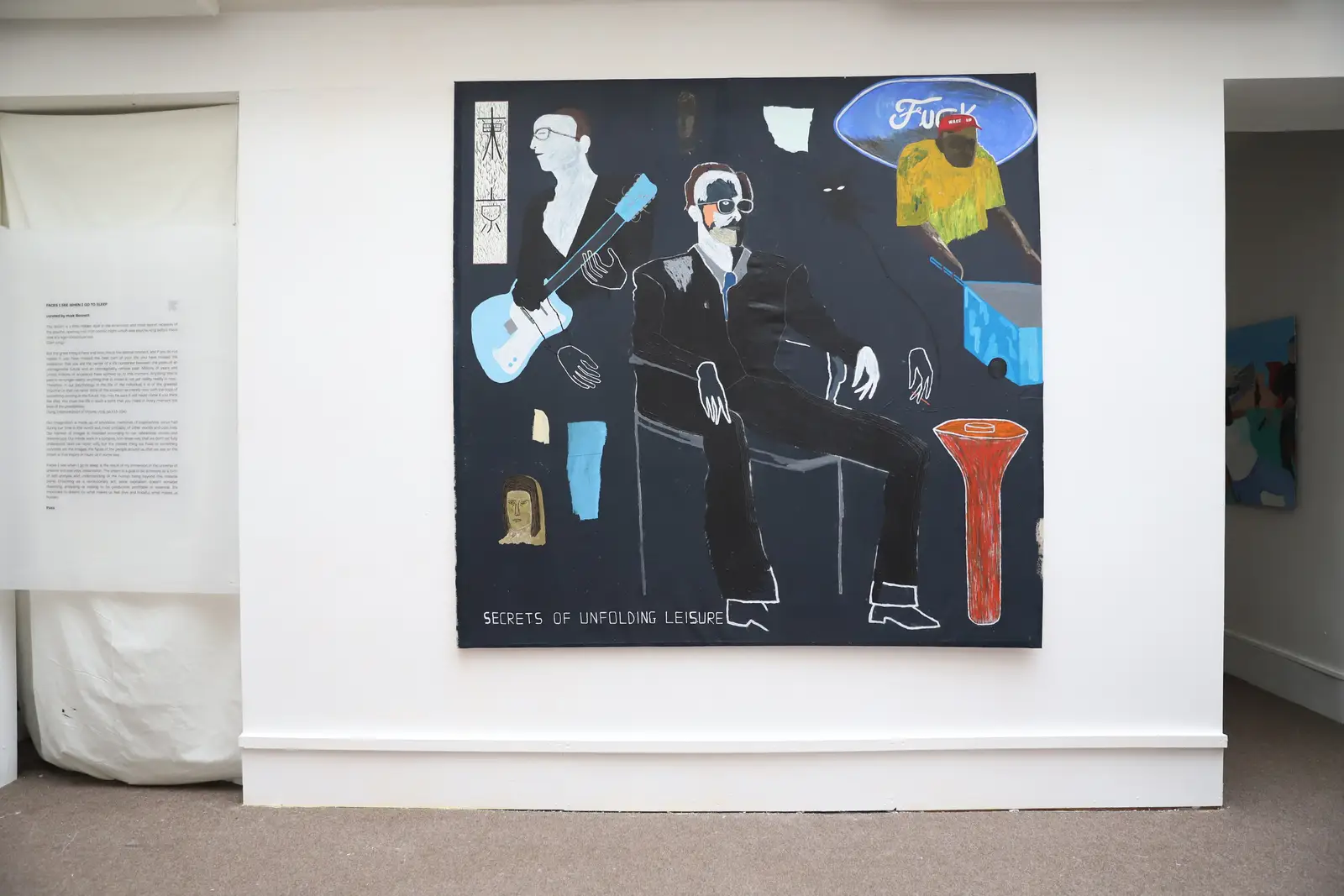 Paes painting Secrets of Unfolding Leisure installed on a gallery wall, featuring seated figures, floating objects, and text elements.