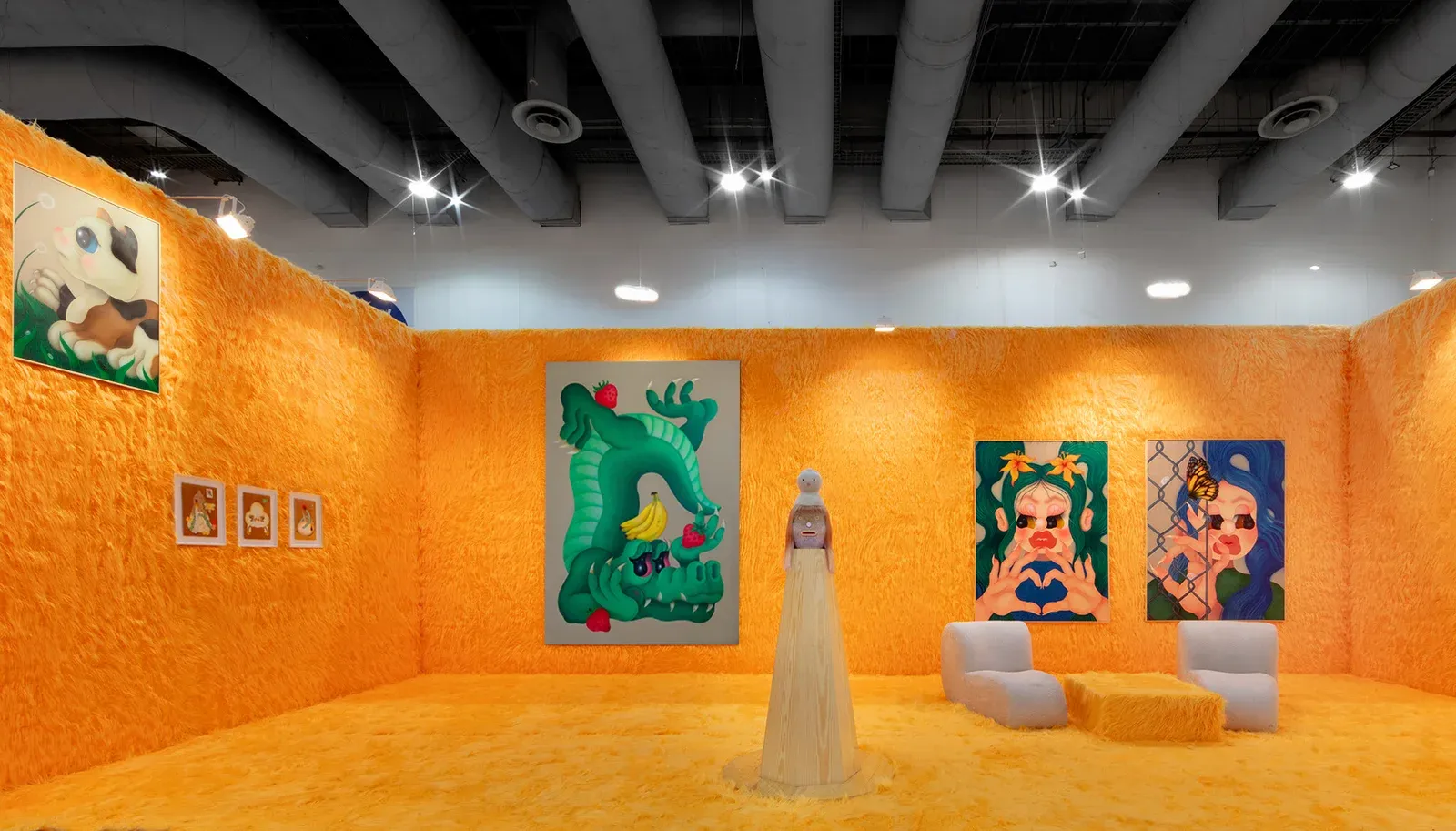 Installation view of Fátima de Juan’s booth at Zona Maco Art Fair, Mexico, featuring large figurative paintings and sculptural elements within a fully orange, immersive exhibition space.