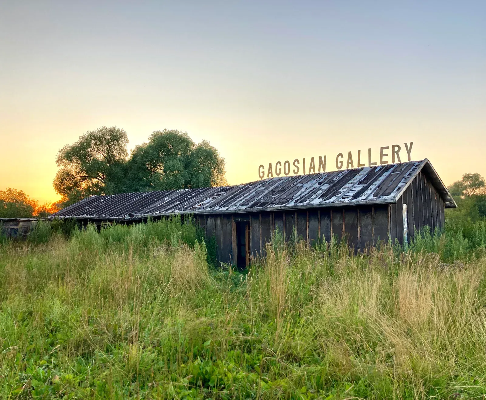 Ivan Volkov, satirical intervention, gagosian gallery logo at a barn, abandoned landslide