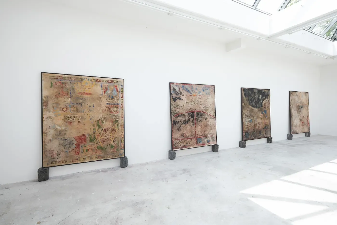 Exhibition view of contemporary paintings by Ruben Einsmann installed along a white gallery wall.