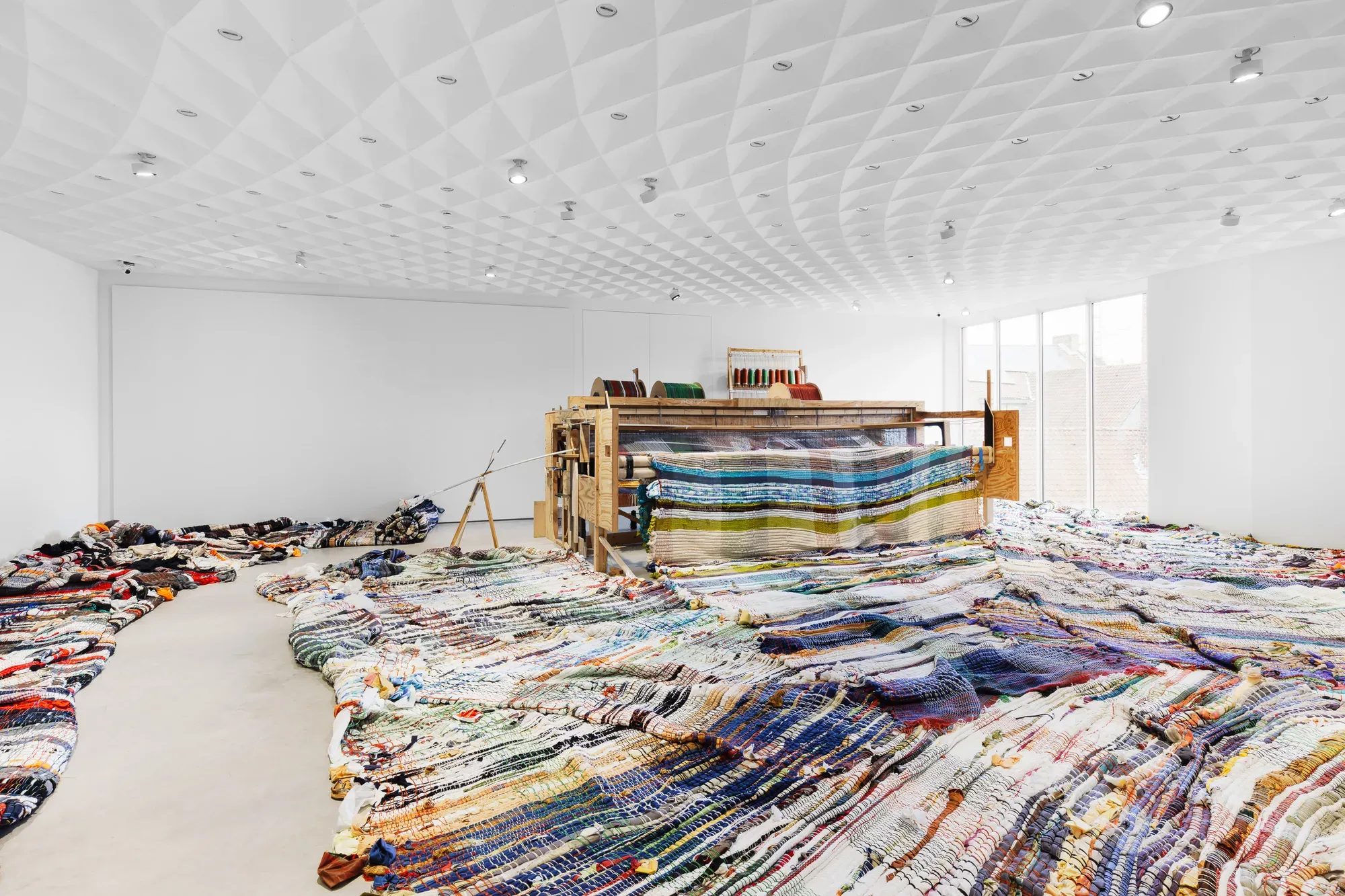 michael beutler, large scale art installation - weaving machine with large carpets , textile colorful view exhibition view,