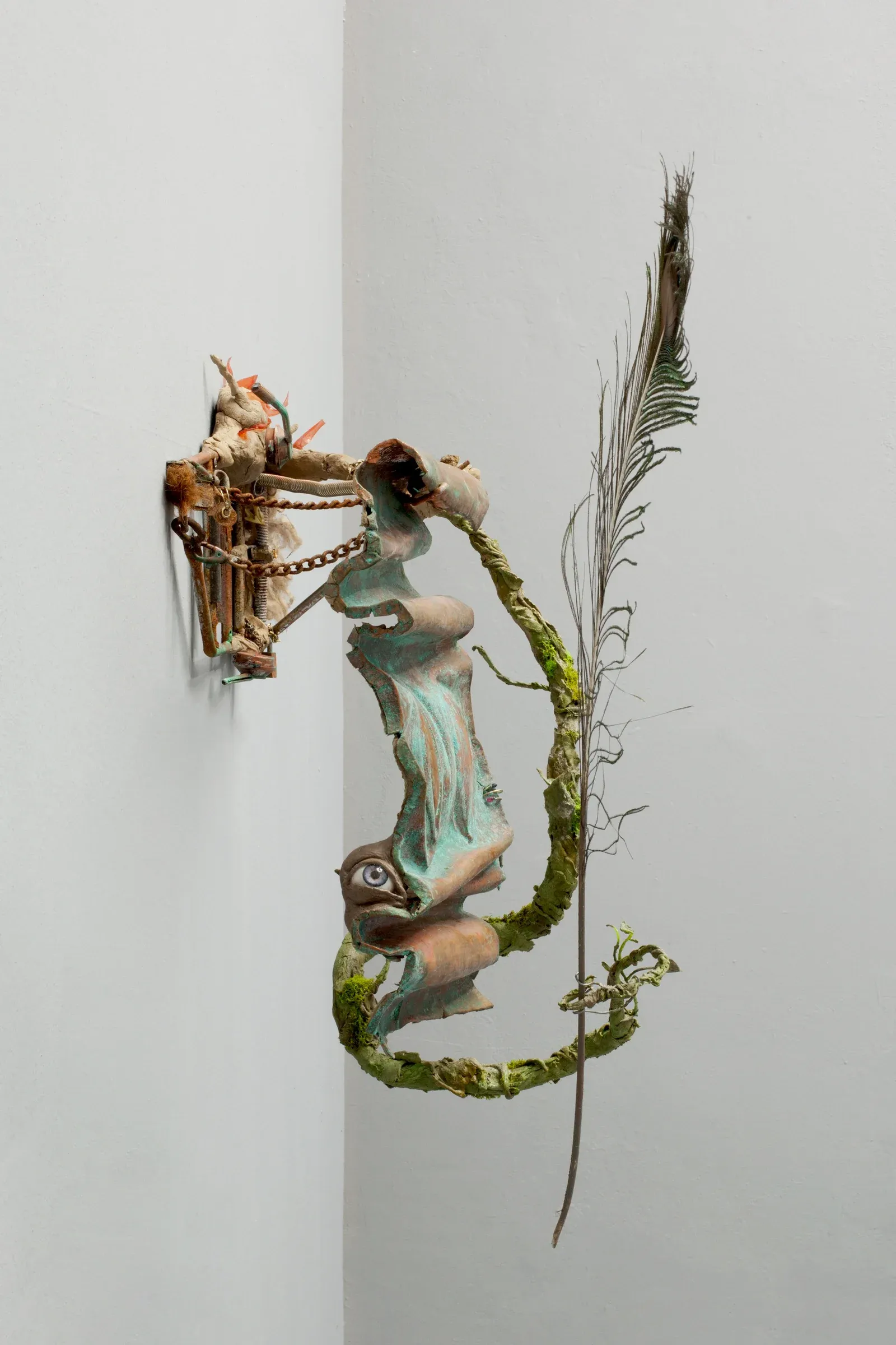Compact mixed-media sculpture by Michele Gabriele integrating feathers, metal, and concrete, exhibited at Kunsthalle.Ost Leipzig.