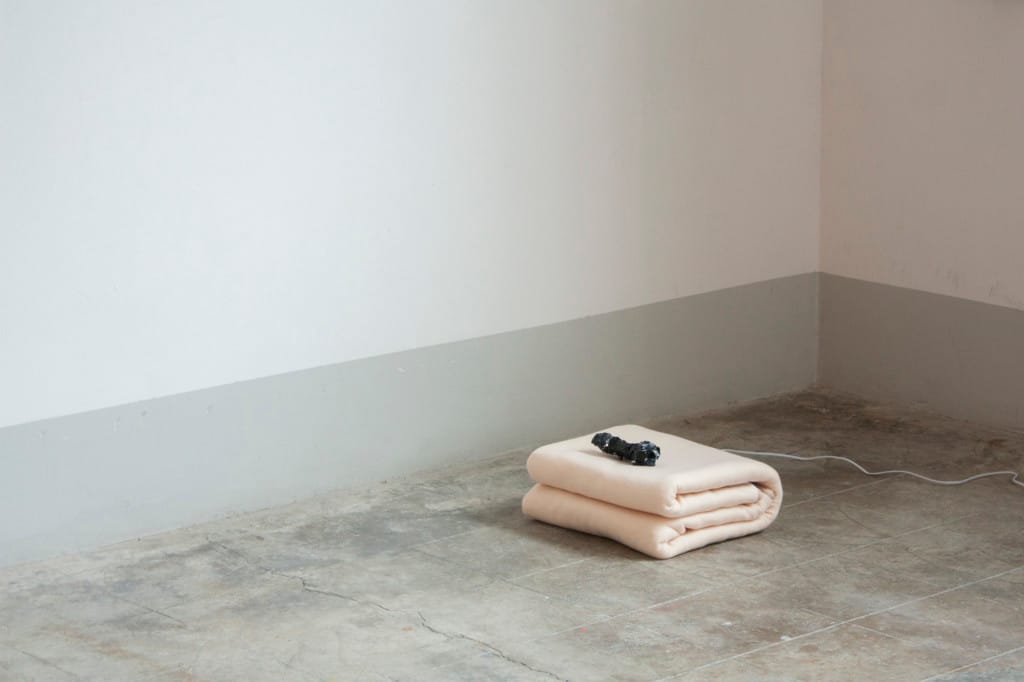 Luca Vanello Generous Images Unable To Reach sculptural installation featuring folded thermal blanket with embedded technological elements on gallery floor