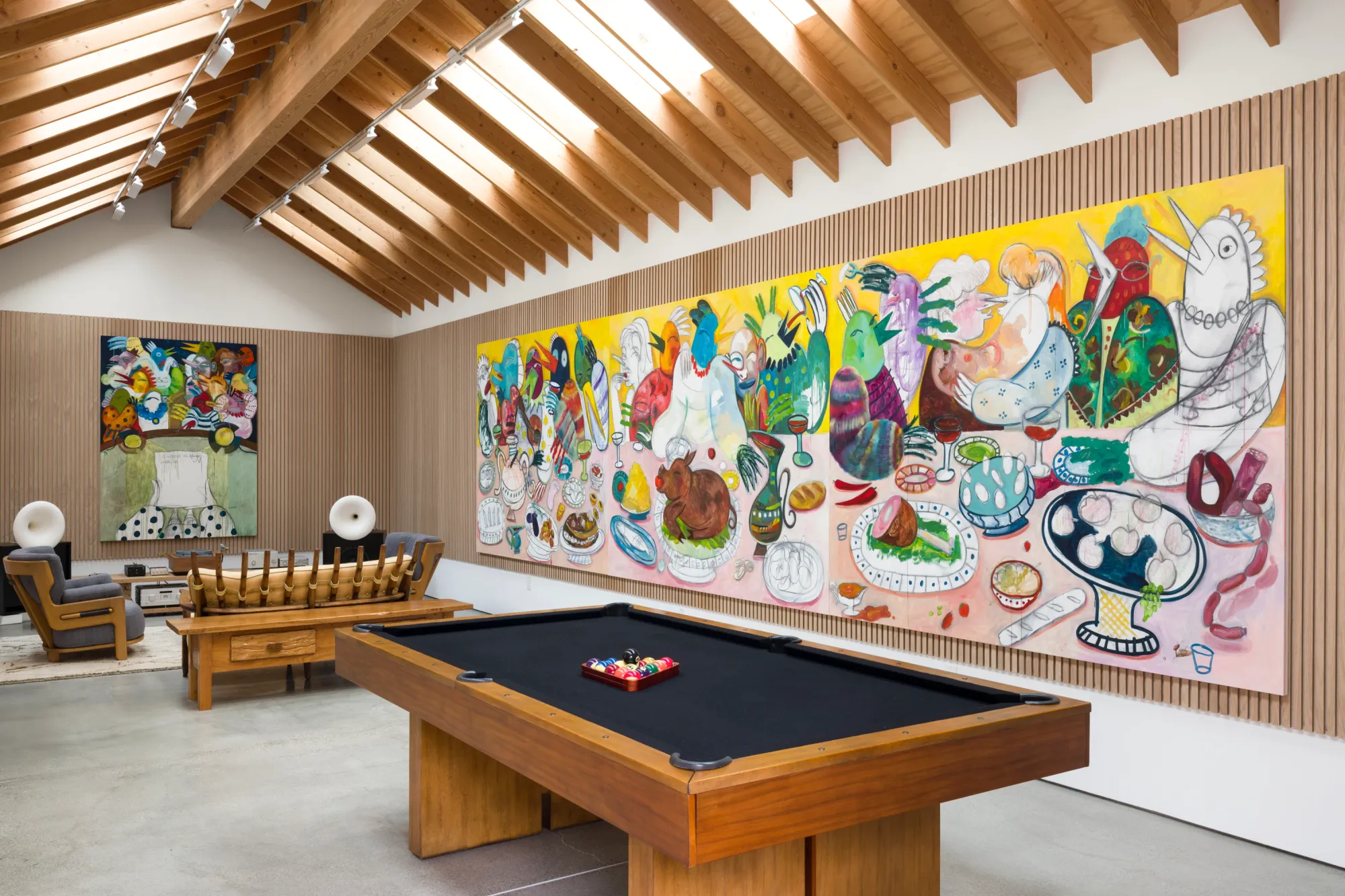 Installation view of Dinner Table at Simchowitz Hilltop, Los Angeles, featuring large paintings by Lera Derkach displayed in a wood-lined gallery interior with pool table and lounge seating.