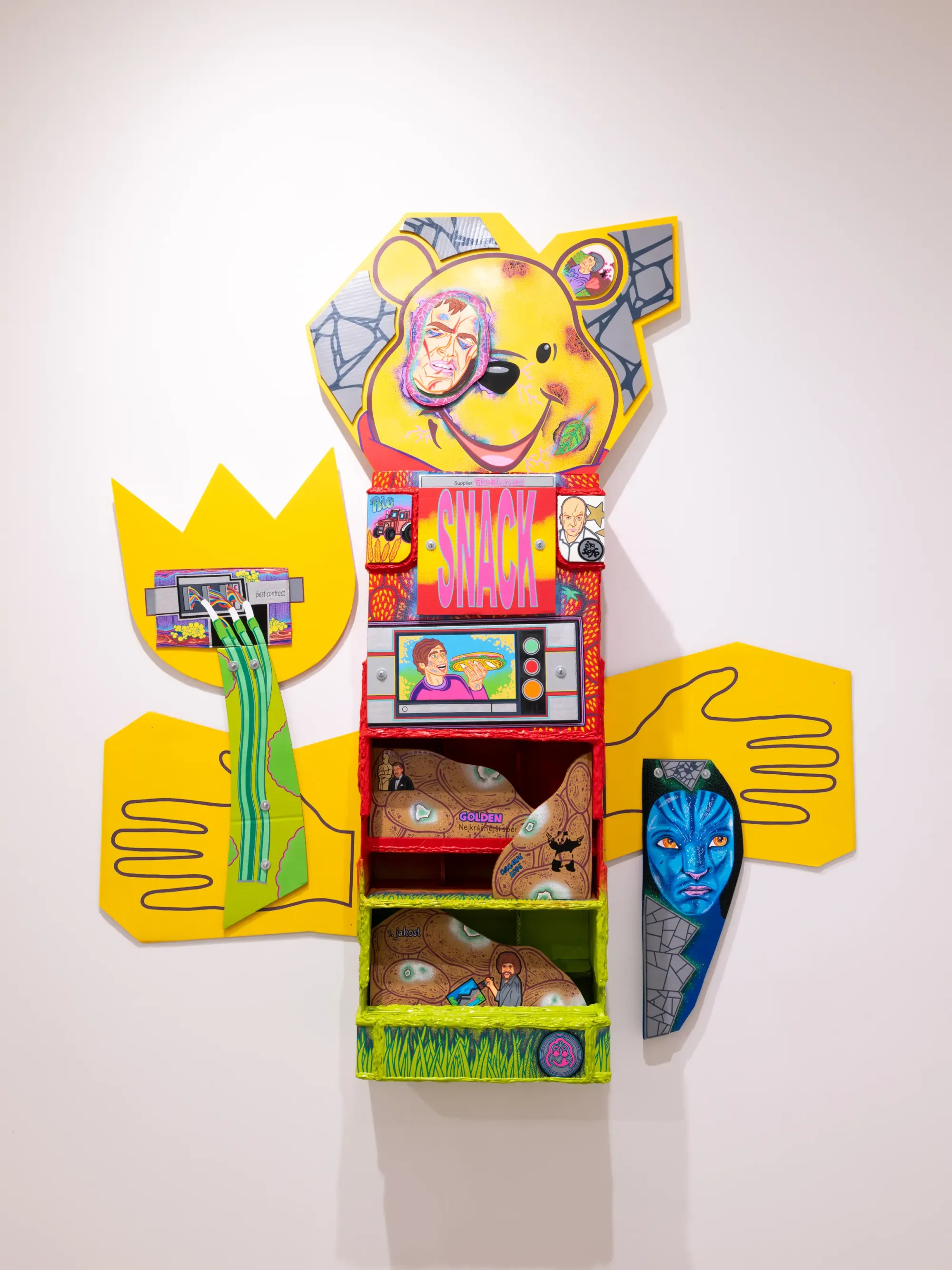 Colorful cardboard vending machine shaped like Winnie the Pooh with illustrated shelves and graphic elements, Daniela Ponomarevová sculpture