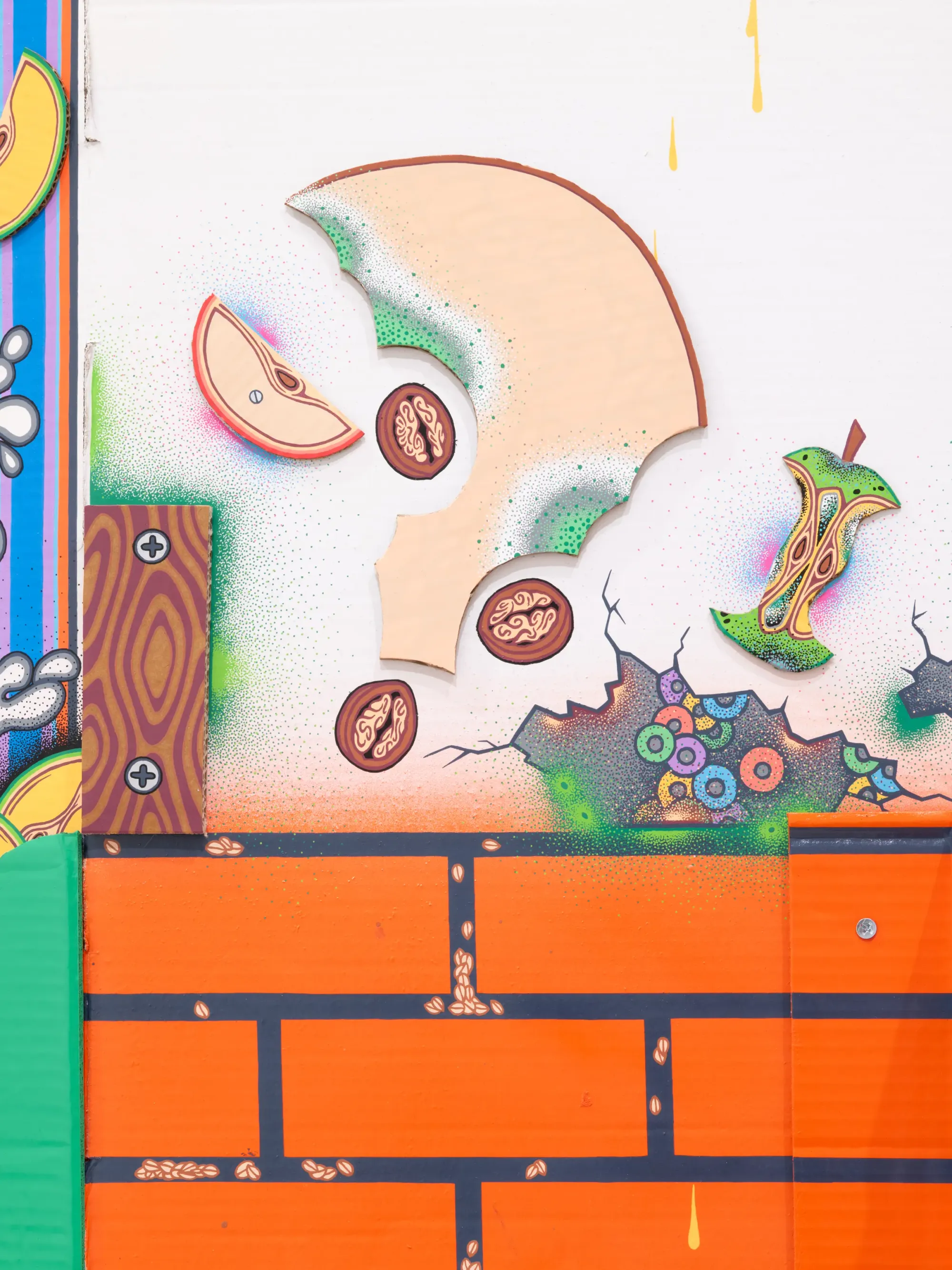 Close-up of illustrated cardboard detail showing eaten apple fragments and graphic textures, Daniela Ponomarevová