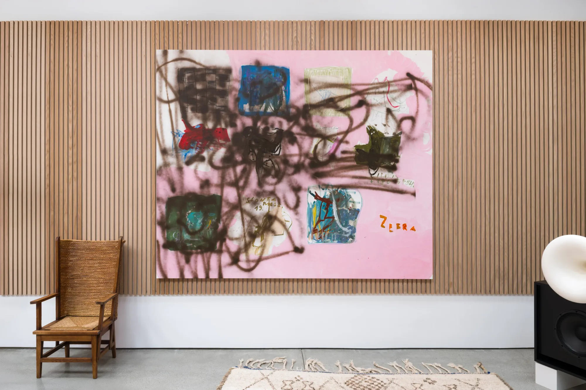 Installation view of Dinner Table at Simchowitz Hilltop, Los Angeles, featuring a large abstract painting by Lera Derkach on a wood-paneled wall.