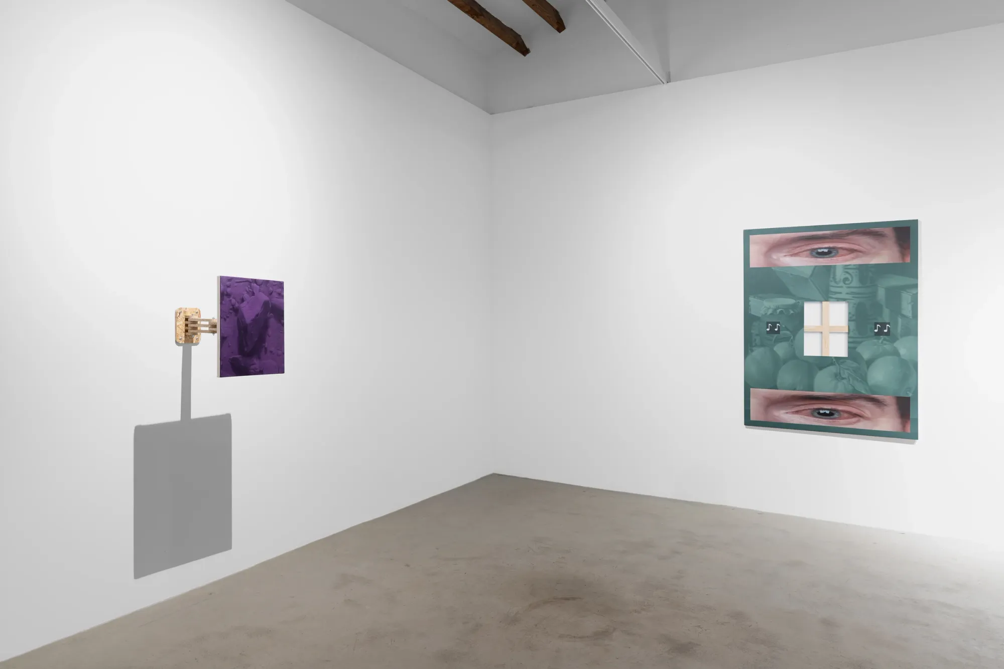 Installation detail of Paul Riedmüller exhibition at LA BIBI-Reus Gallery Mallorca showing wall-mounted work with wooden bracket and framed image composition with eye motifs