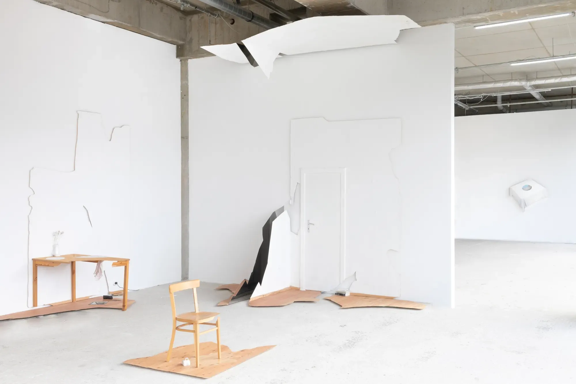 Detail of Tobias John’s installation Fails (2025) showing fragmented wall panels and floor elements inside the exhibition Call Someone at ayayay Frankfurt