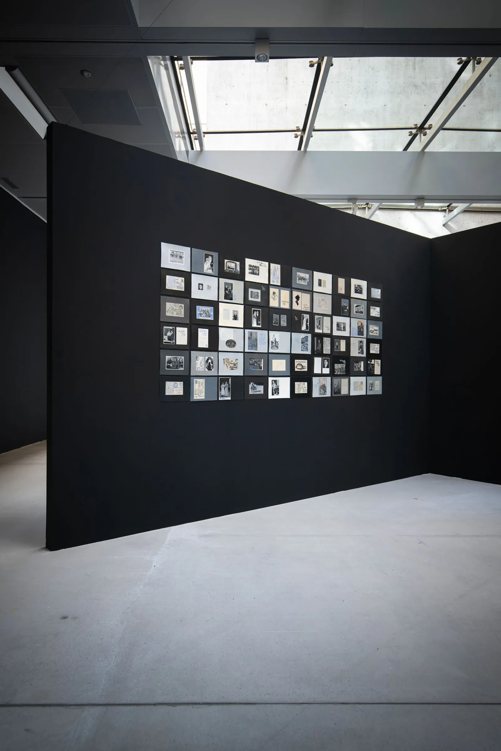 Ramesch Daha paintings from the archive installation grid black wall TAXISPALAIS Innsbruck exhibition view
