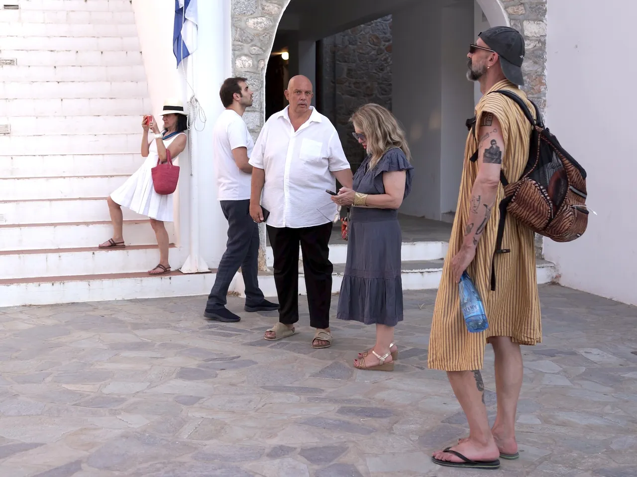 Dimitrios Antonitsis, founder and curator of Hydra School Projects, giving a private tour of the 2025 exhibition Lithos Lethe in the courtyard of Hydra’s former school building, Greece.