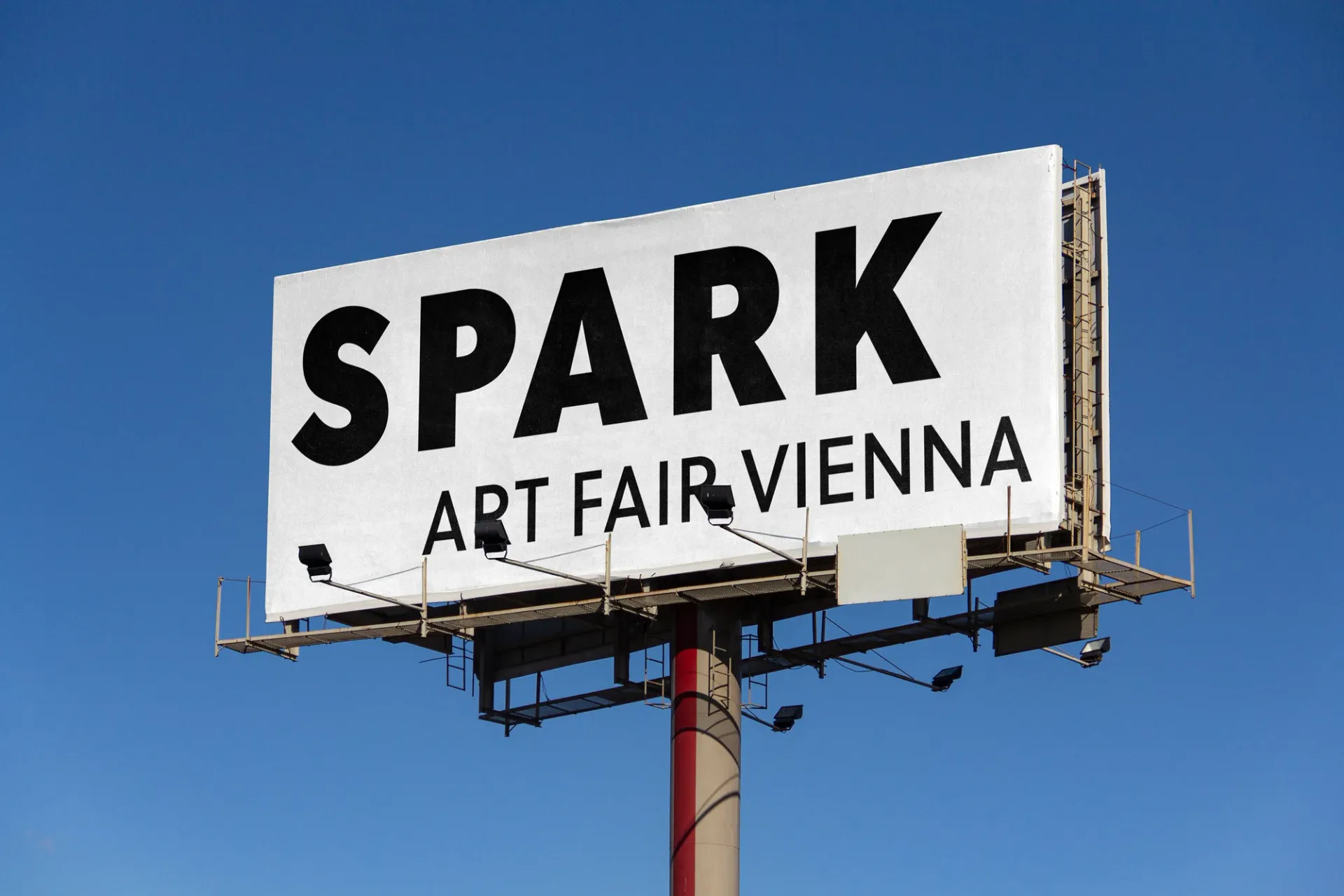 SPARK Art Fair Vienna billboard against blue sky, announcing SPARK Art Fair Vienna 2026 at MARX HALLE with focus on solo artist presentations