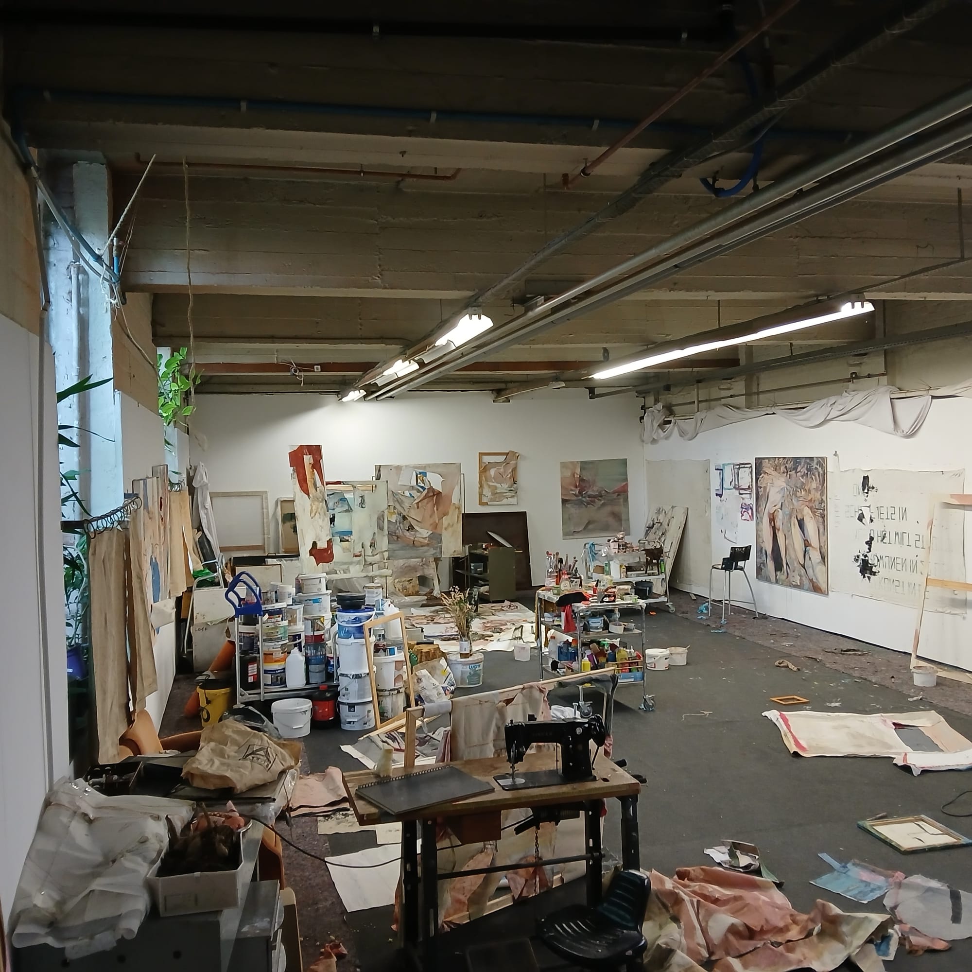 Ruth Devriendt, artist  studio during her interview with Di Franco, showing large canvases, tools and works in progress across the space. Installation view courtesy of the artist.